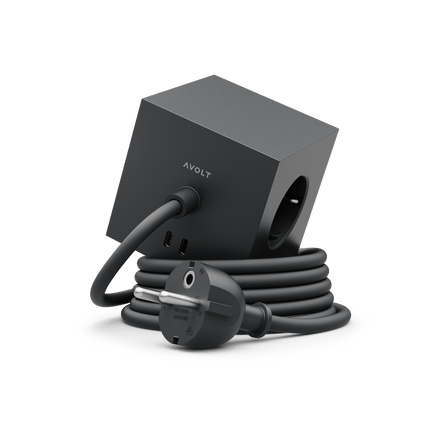 Avolt Square 1 - Black power strip, USB-C charger, and coiled power cord on a white base.